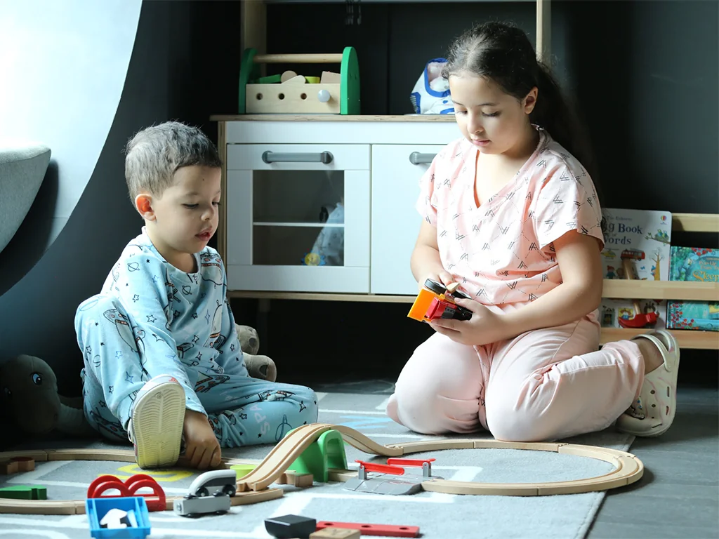 Children playing with wooden toys in the Kids’ Space at Blu Monkey Bangtao