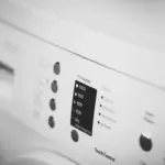 Front-loading washing machine representing practical laundry planning for a longer hotel stay