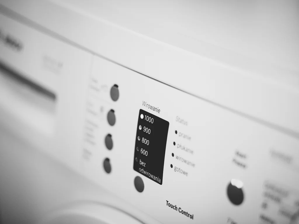 Front-loading washing machine representing practical laundry planning for a longer hotel stay